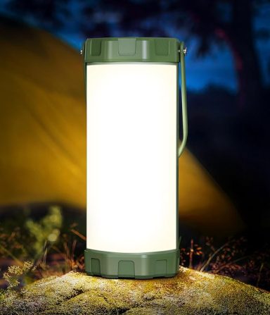 Portable lantern with a white light, set against a dark, outdoor camping scene.