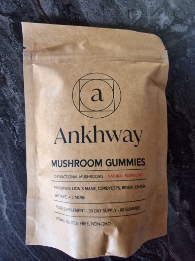 Brown paper packaging for Ankhway mushroom gummies, featuring product name and details.