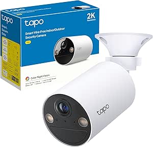 White outdoor security camera beside its packaging box.
