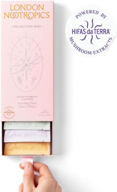 Hand pulling out a drawer from a pink box labelled "London Tropics" with herbal tea sachets.