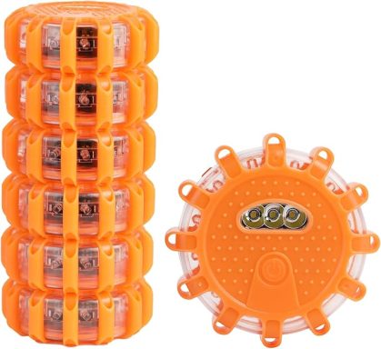 Stack of six orange safety lights with one light positioned beside them.