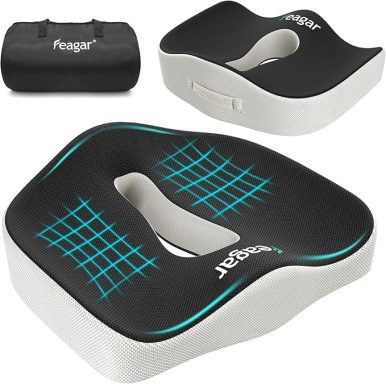 Black and white ergonomic seat cushion with a cut-out section and handle.