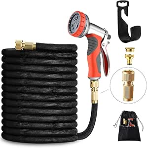 Black garden hose coiled with a spray gun, holder, and connector.