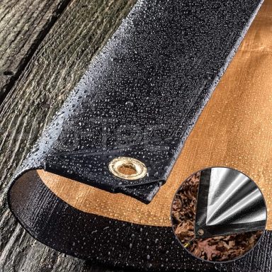 Water-resistant tarp with water droplets, showing a brass grommet and wooden surface underneath.