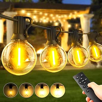 String lights with glowing bulbs and a remote control, set in an outdoor setting.